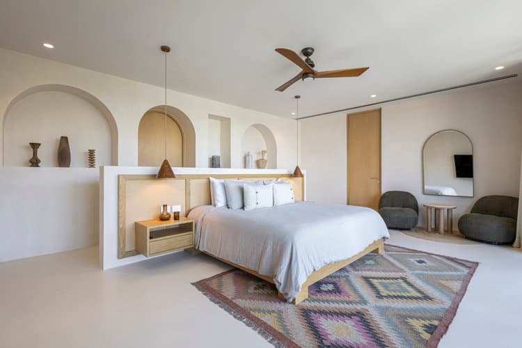 Luxury suite bedroom with designer finishes at Aflora Tulum